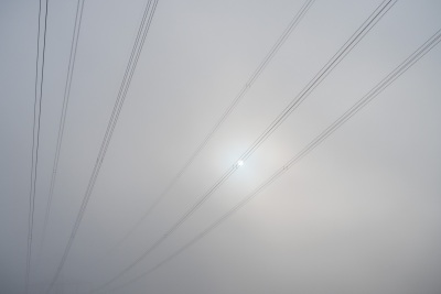 Seile einer Freileitung im Nebel