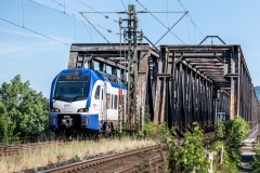 Ein Zug der S-Bahn Hannover überquert die Weserbrücke bei Emmerthal.